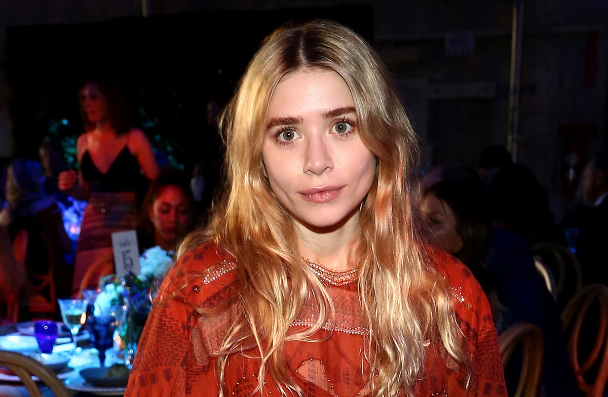Ashley Olsen’s boyfriend captures her hiking through the woods with a machete — and a drink