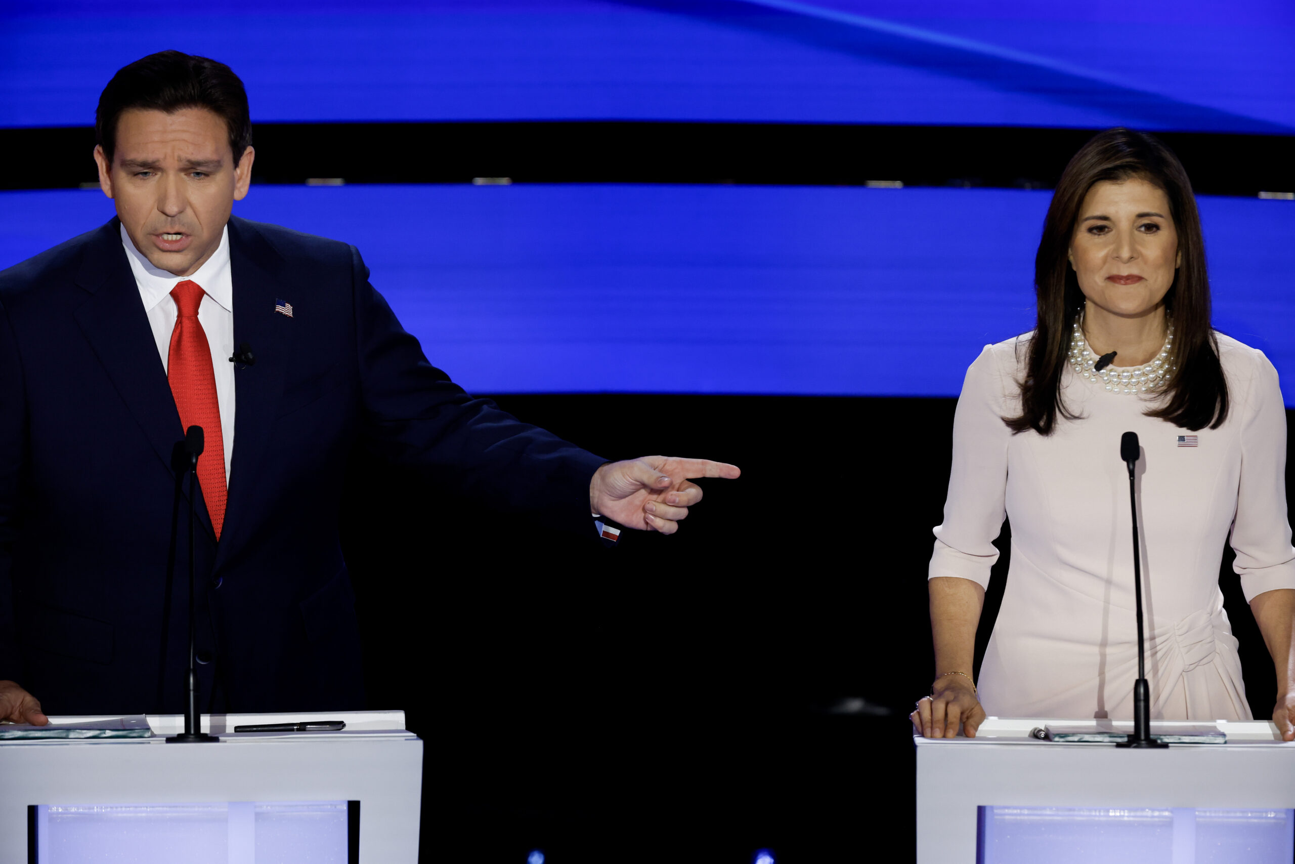 DeSantis and Haley trade accusations at Iowa debate while Trump holds separate town hall